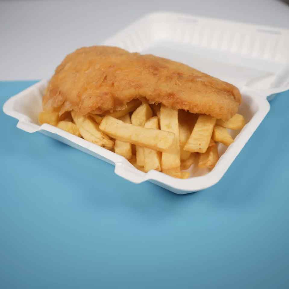 A piece of battered fried fish on top of a bed of thick-cut French fries.